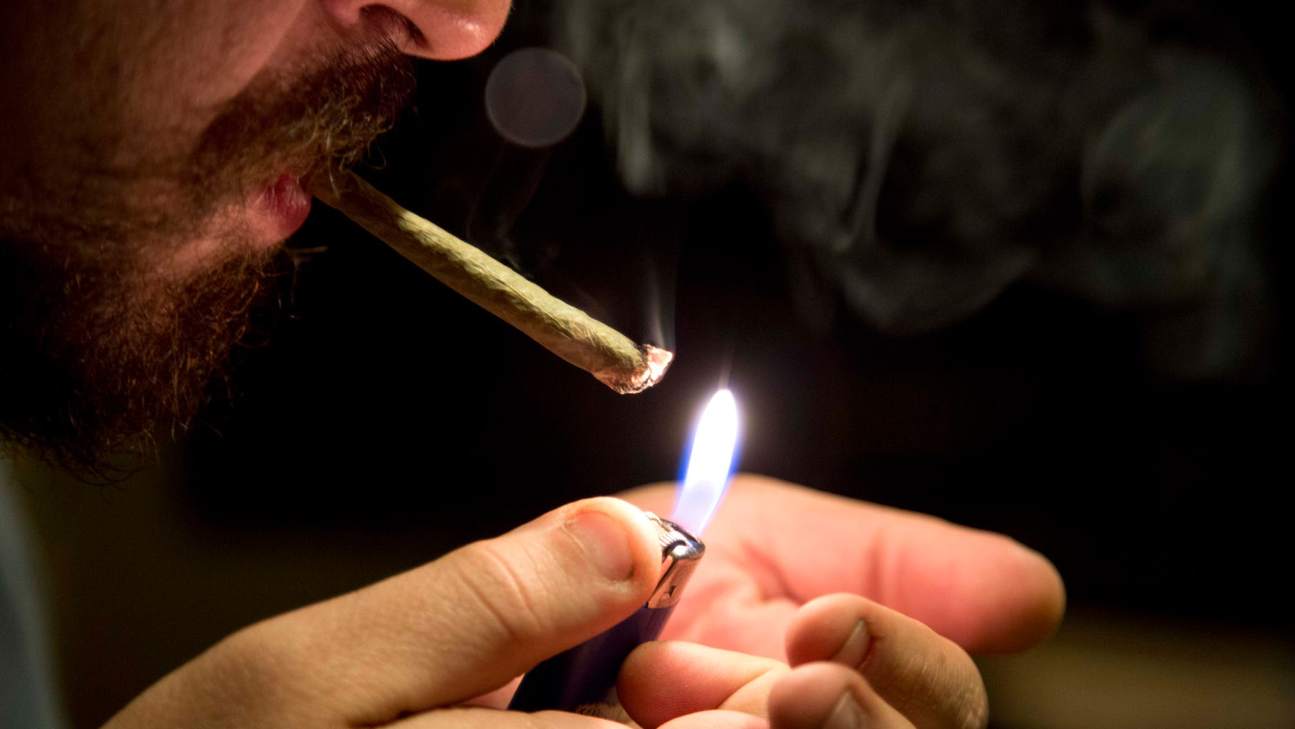 FILE - In this Oct. 29, 2013, file photo, a man smokes marijuana inside his apartment where he uses a hydroponics system to grow his weed in Mexico City. The Mexican government has awarded, on Friday, Dec. 11, 2015, four people the first permits allowing growing and possession of marijuana for personal use. The governments medical protection agency says the permits apply only to the four plaintiffs who won a November Supreme Court ruling. The permits dont allow smoking marijuana in the presence of children, or anyone who hasnt given their consent. (AP Photo/Eduardo Verdugo, File)