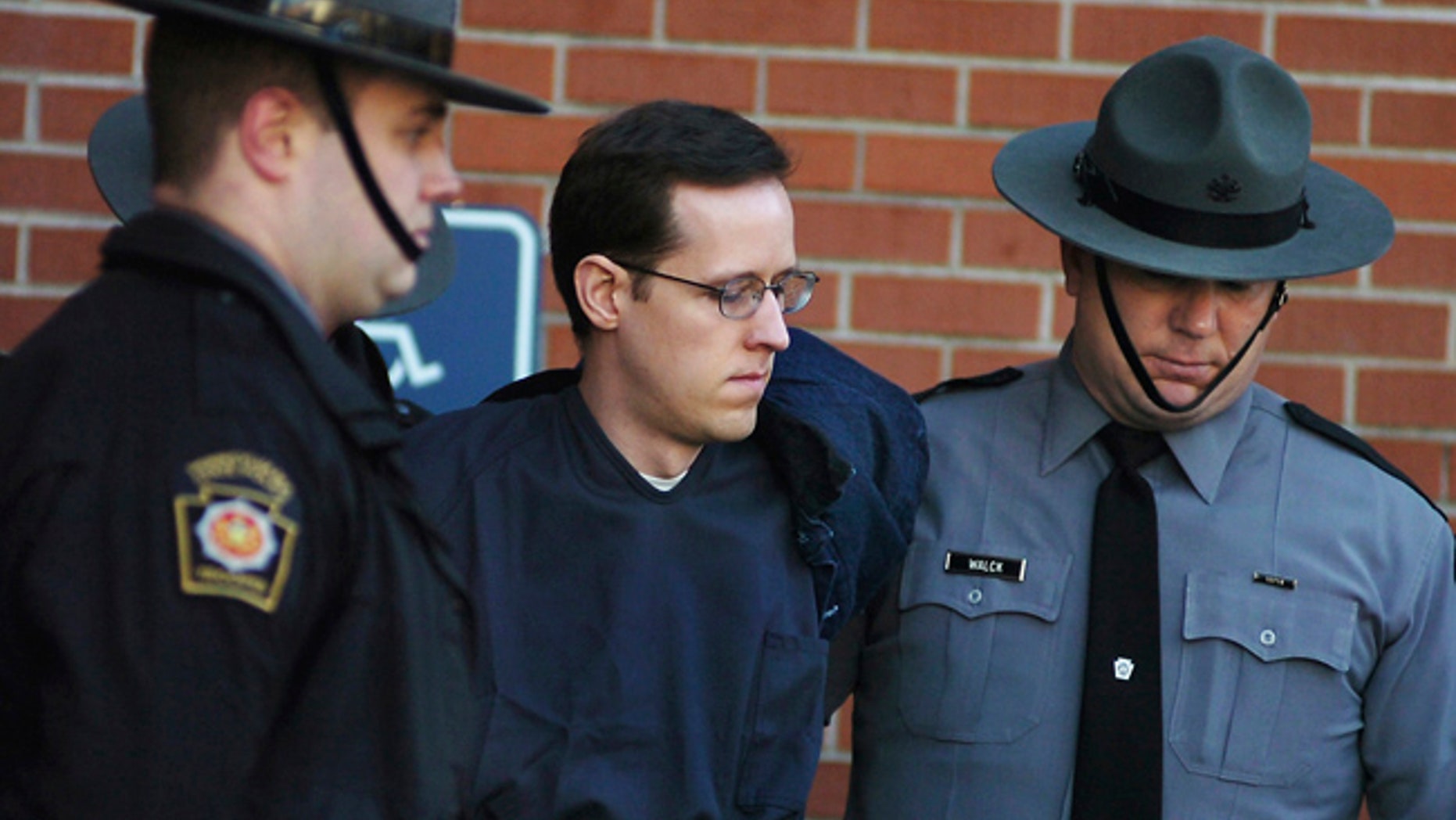 FILE - In this Jan. 5, 2015, file photo, Eric Frein is led away by Pennsylvania State Police Troopers at the Pike County Courthouse after his preliminary hearing in Milford, Pa. Attorneys for Frein, charged in the 2014 ambush slaying of Pennsylvania Police Cpl. Bryon Dickson II, are asking a judge on the eve of his trial to throw out his videotaped confession. (Butch Comegys/The Times & Tribune via AP, File)