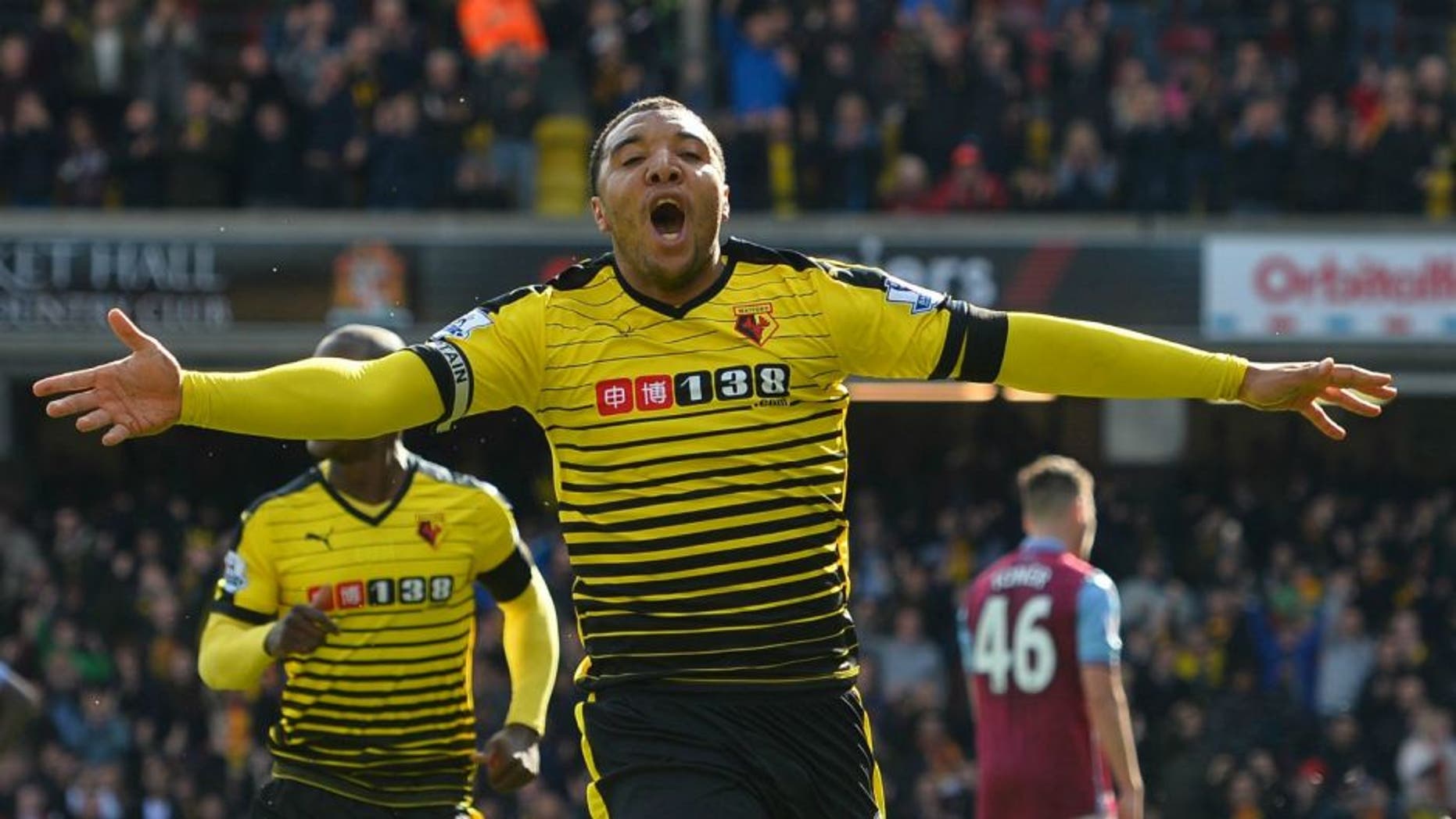 Watford's English striker Troy Deeney celebrates after scoring his second goal during the English Premier League football match between Watford and Aston Villa at Vicarage Road Stadium in Watford, north of London on April 30, 2016. / AFP / GLYN KIRK / RESTRICTED TO EDITORIAL USE. No use with unauthorized audio, video, data, fixture lists, club/league logos or 'live' services. Online in-match use limited to 75 images, no video emulation. No use in betting, games or single club/league/player publications. / (Photo credit should read GLYN KIRK/AFP/Getty Images)