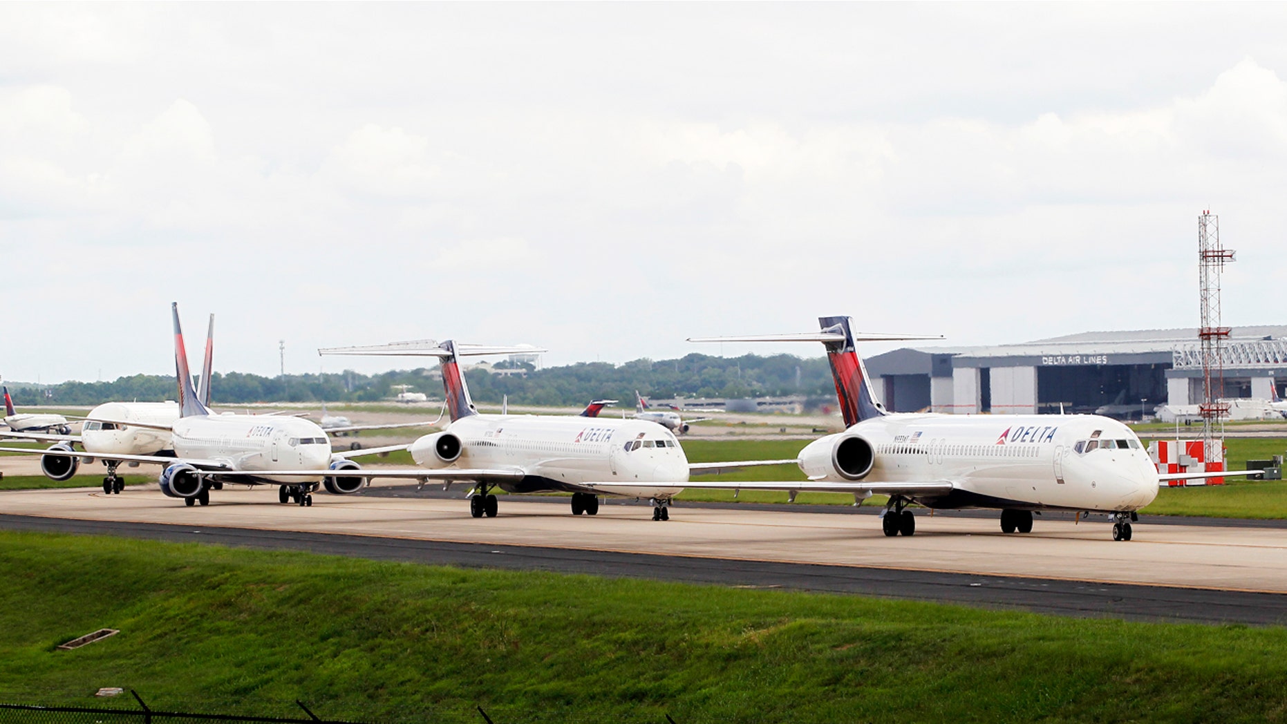 Delta airplanes line up on the taxi way at Hartsfield Jackson Atlanta International Airport.