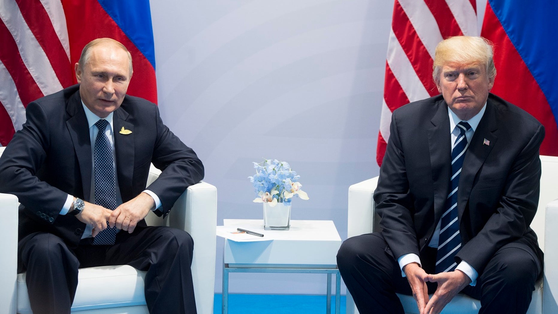 FILE - In this July 7, 2017, file photo, U.S. President Donald Trump, right, and Russian President Vladimir Putin pose for a photo during the G20 summit in Hamburg Germany. (AP Photo/Marcellus Stein, File)