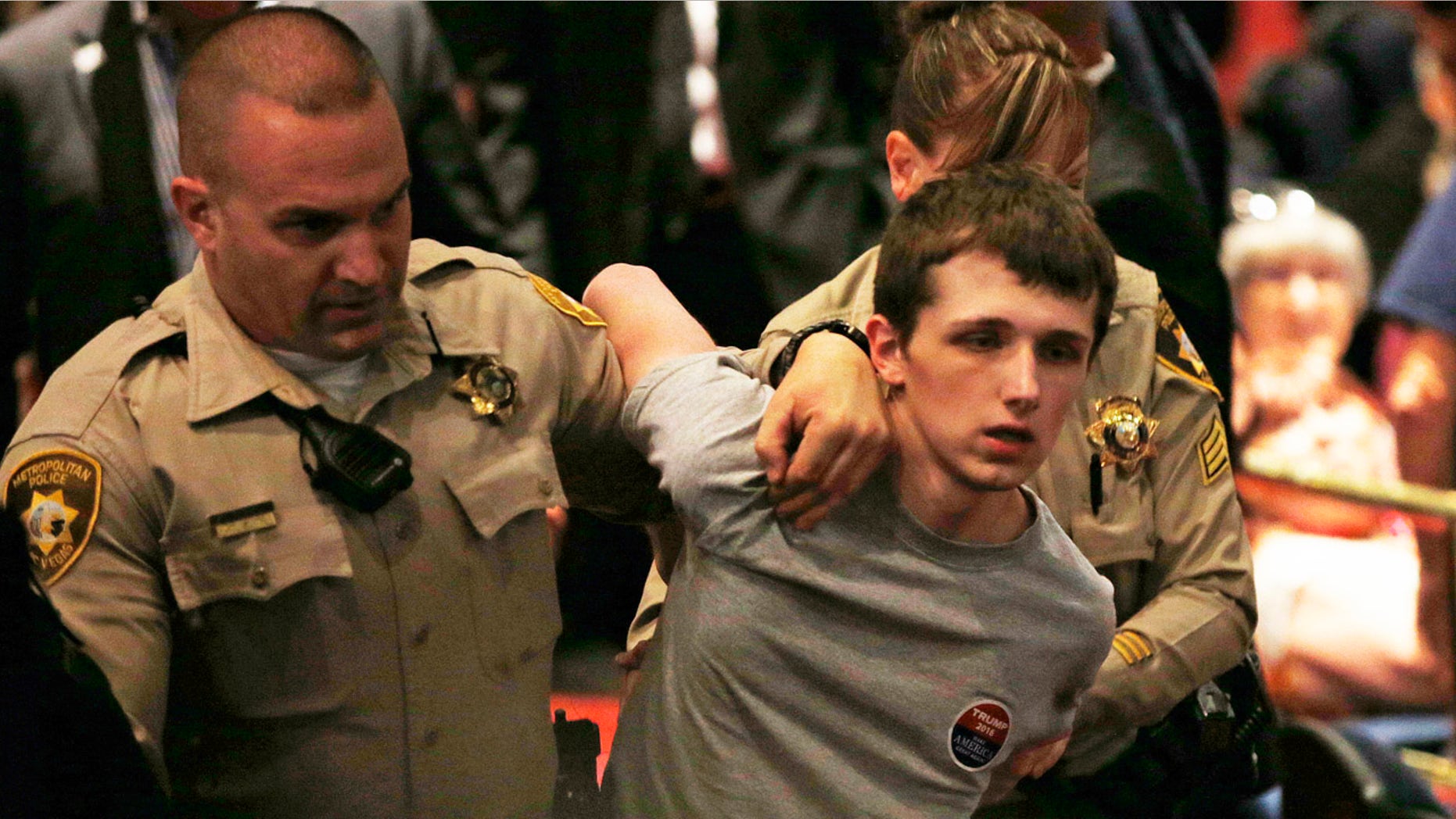 June 18, 2016: Police remove Michael Sandford as Republican presidential candidate Donald Trump speaks at the Treasure Island hotel and casino in Las Vegas.