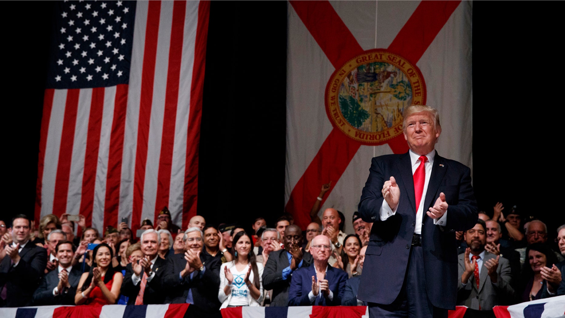 June 16, 2017: President Donald Trump applauds as he arrives to speak about Cuba policy in Miami. The president announced changes to Obama-era Cuba policy, and challenged the Castro government to negotiate a better deal.