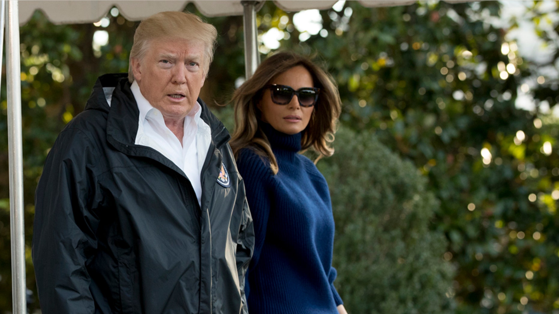President Donald Trump, accompanied by first lady Melania Trump, walks to board Marine One on the South Lawn of the White House in Washington, Tuesday, Oct. 3, 2017. (AP Photo/Andrew Harnik)