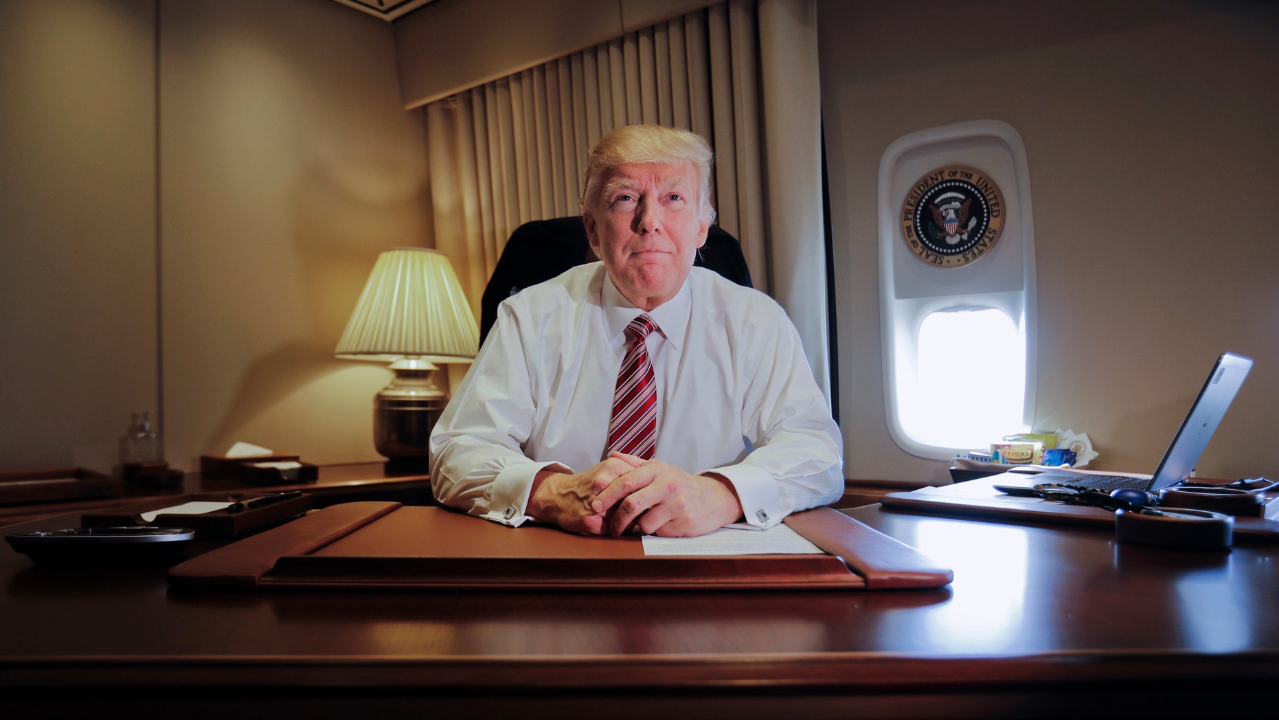 President Donald Trump sits at his desk on Air Force One upon his arrival at Andrews Air Force Base, Md., Thursday, Jan. 26, 2017. (AP Photo/Pablo Martinez Monsivais)