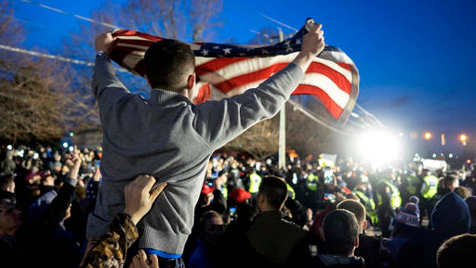 A Donald Trump supporter waves an American flag at a Trump campaign rally in Bethpage, N.Y., April 6, 2016.
