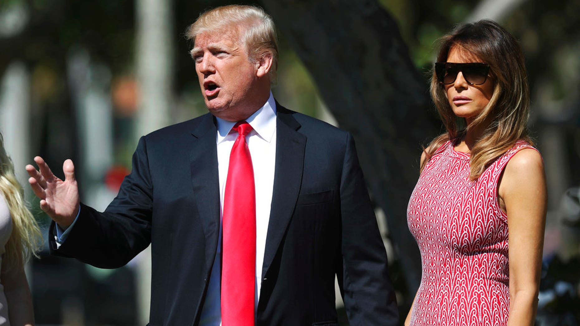 President Donald Trump stops to speak to members of the media as he arrives for Easter services with first lady Melania Trump at Episcopal Church of Bethesda-by-the-Sea in Palm Beach, Fla., Sunday, April 1, 2018. (AP Photo/Pablo Martinez Monsivais)