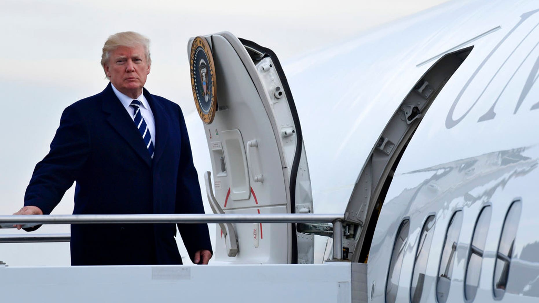 President Donald Trump walks up the steps of Air Force One at John F. Kennedy International Airport in New York, Saturday, Dec. 2, 2017. Trump spent the day in New York attending a trio of fundraisers. (AP Photo/Susan Walsh)
