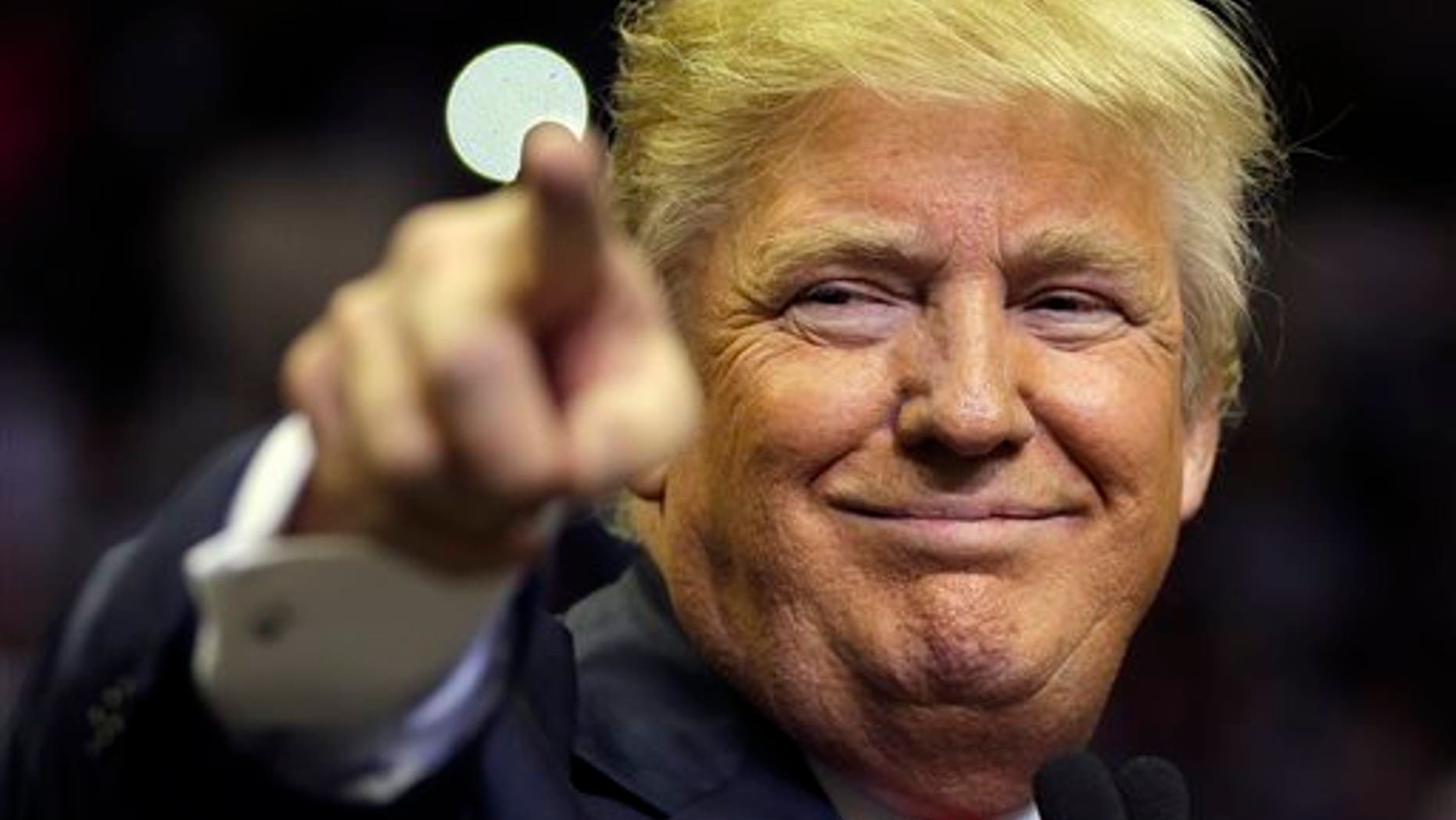 Republican presidential candidate Donald Trump points at a supporter during a rally Friday, Feb. 12, 2016, in Tampa, Fla. (AP Photo/Chris O'Meara)
