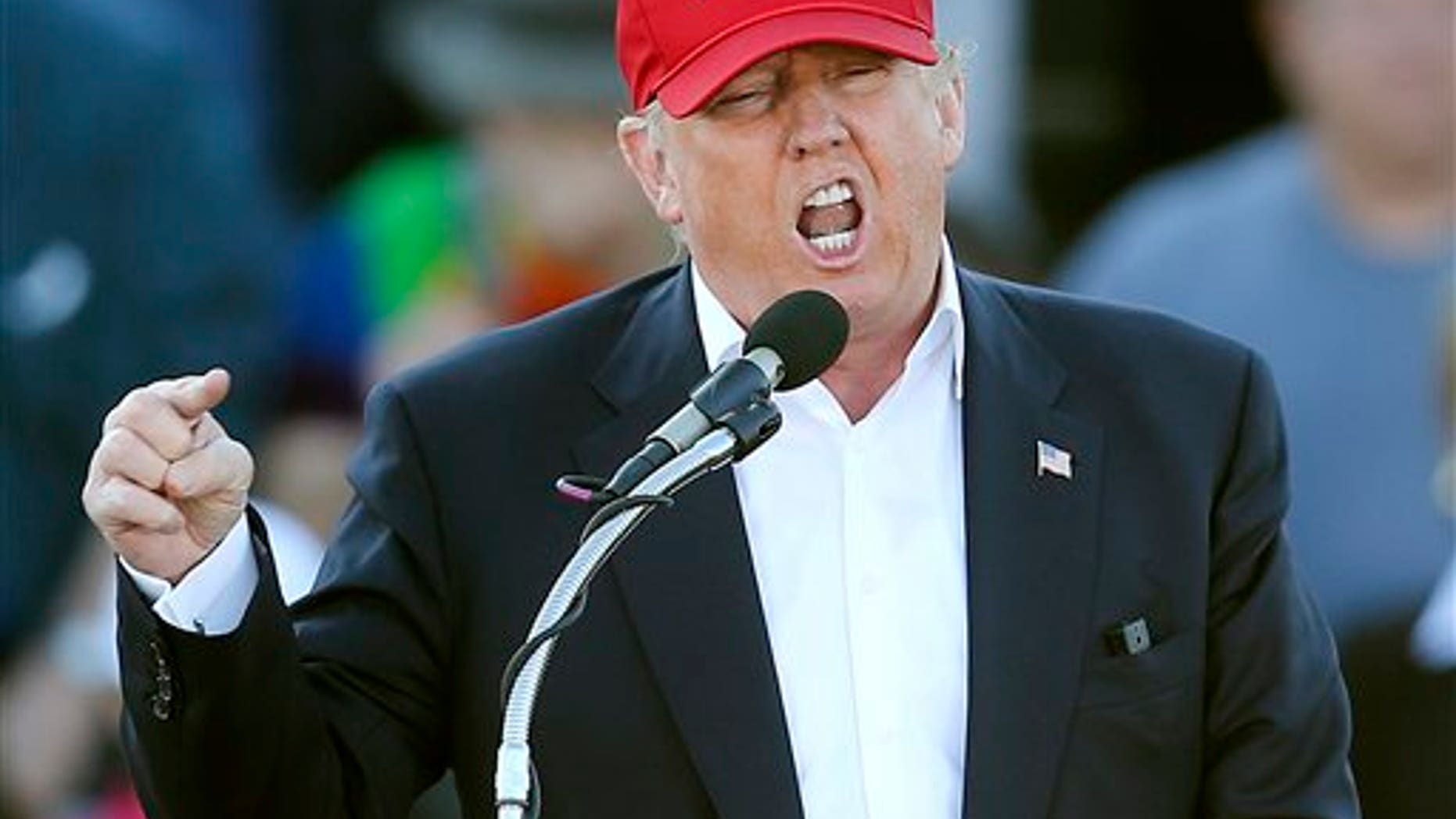 FILE - In this Feb. 28, 2016, file photo, Republican presidential candidate Donald Trump speaks during a rally in Madison, Ala. Republican presidential front-runner Trump has staked out uncompromising positions on Asia policy that could potentially strain U.S. relations with the region if he wins the White House. He says China is ripping off America in trade and should be slapped with a fat import tax. And he claims U.S. military allies Japan and South Korea are freeloading and need to pull their weight. The pan-Pacific trade pact negotiated by the Obama administration is a "total disaster." (AP Photo/John Bazemore, File)