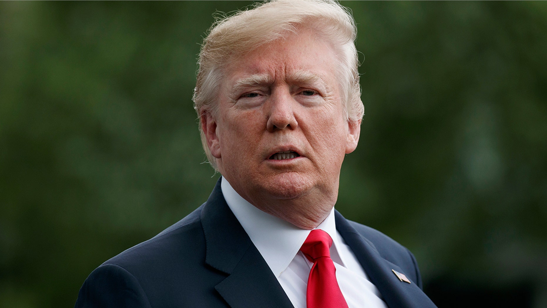 FILE -- President Donald Trump looks to the media as he walks to Marine One across the South Lawn of the White House in Washington, Saturday, April 28, 2018.