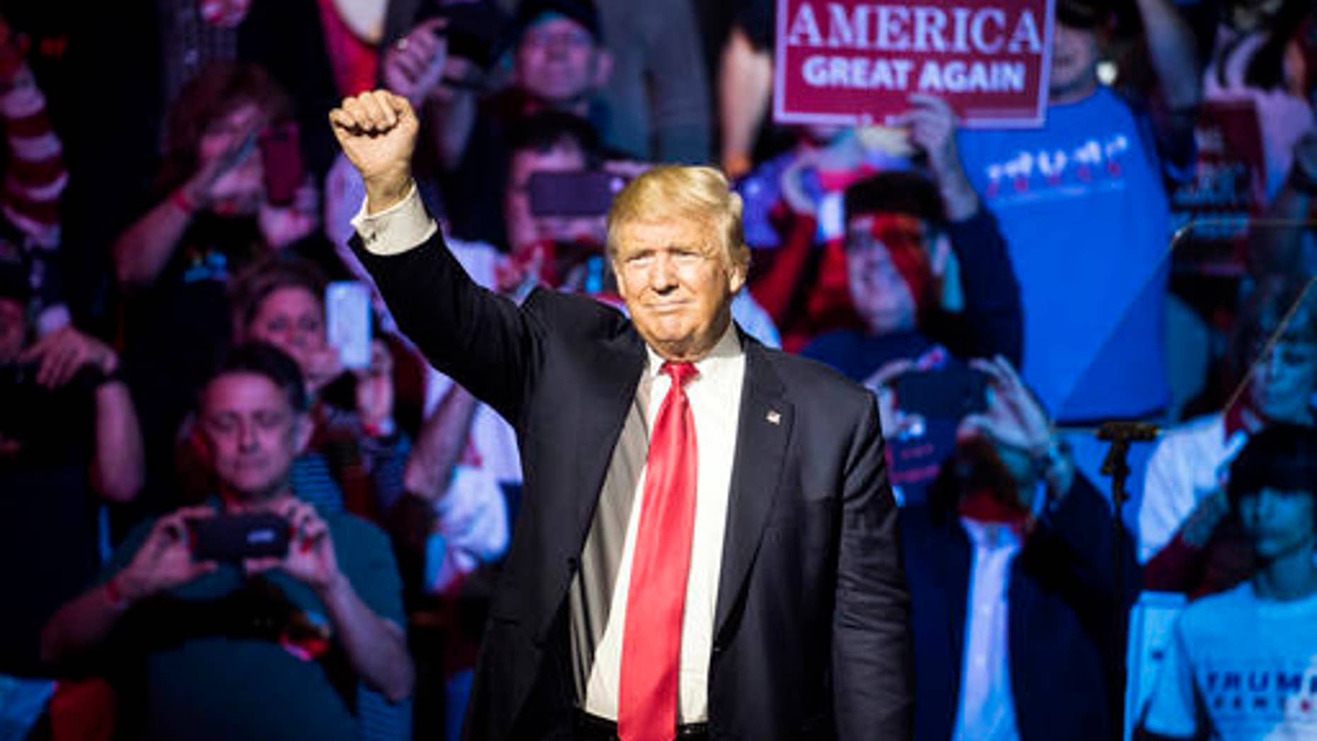 Republican presidential candidate Donald Trump waves to the crowd during a campaign rally, Thursday, Oct. 13, 2016, in Cincinnati. (AP Photo/John Minchillo)