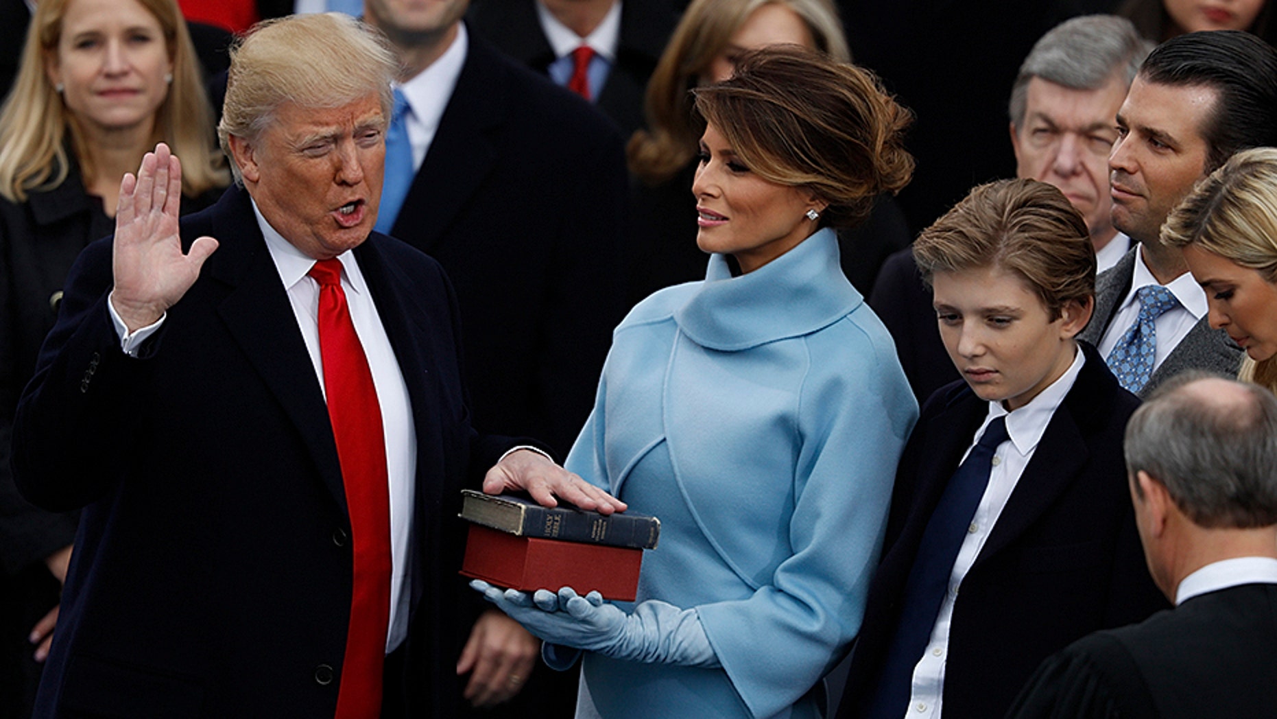 Donald Trump takes the oath of office as his wife Melania holds a Bible and his son Barron looks on during his inauguration as the 45th president of the United States on the West front of the U.S. Capitol in Washington, U.S., January 20, 2017.