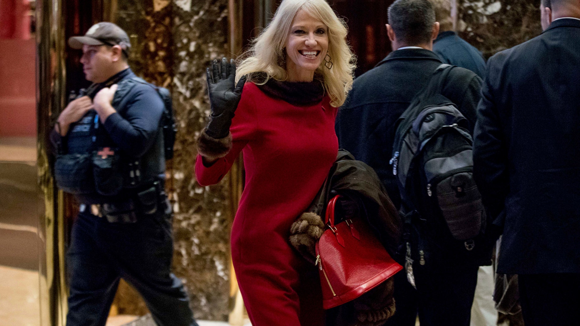 Kellyanne Conway, campaign manager for President-elect Donald Trump, center, walks through the lobby of Trump Tower, Monday, Dec. 5, 2016, in New York. (AP Photo/Andrew Harnik)