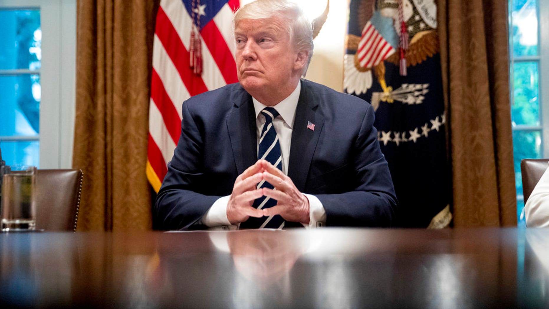 President Donald Trump waits for members of the media get set up before speaking in the Cabinet room of the White House, Tuesday, July 17, 2018, in Washington. Trump says he meant the opposite when he said in Helsinki that he doesn't see why Russia would have interfered in the 2016 U.S. elections.. (AP Photo/Andrew Harnik)