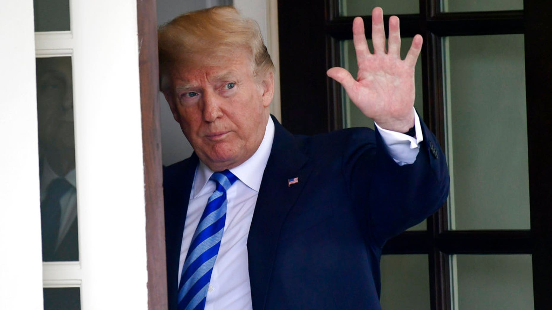 FILE - In this Wednesday, May 16, 2018, file photo, U.S. President Donald Trump waves from the White House, in Washington. In a series of tweets Sunday, May 20, 2018, Trump skims over the facts involving the investigations into Russian meddling in the 2016 election. (AP Photo/Susan Walsh, File)