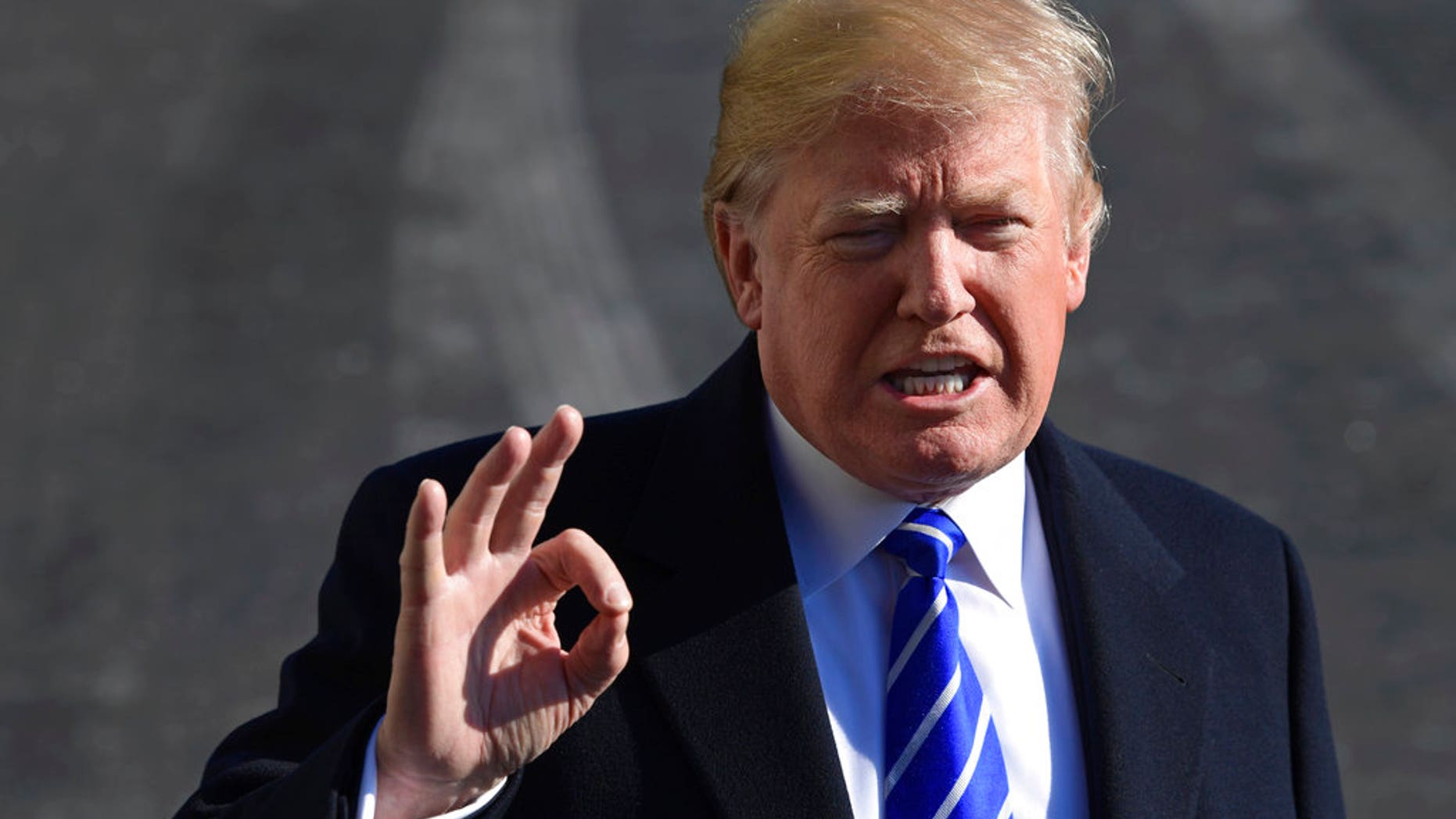President Donald Trump talks with reporters as he departs from the South Lawn of the White House via Marine One in Washington, Saturday, Dec. 16, 2017, to spend the weekend at Camp David in Maryland. (AP Photo/Susan Walsh)