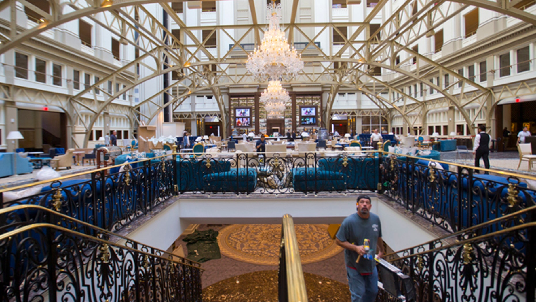 Workers move around inside the Trump International Hotel during it's 'soft-opening' in downtown Washington, Monday, Sept. 12, 2016 in Washington