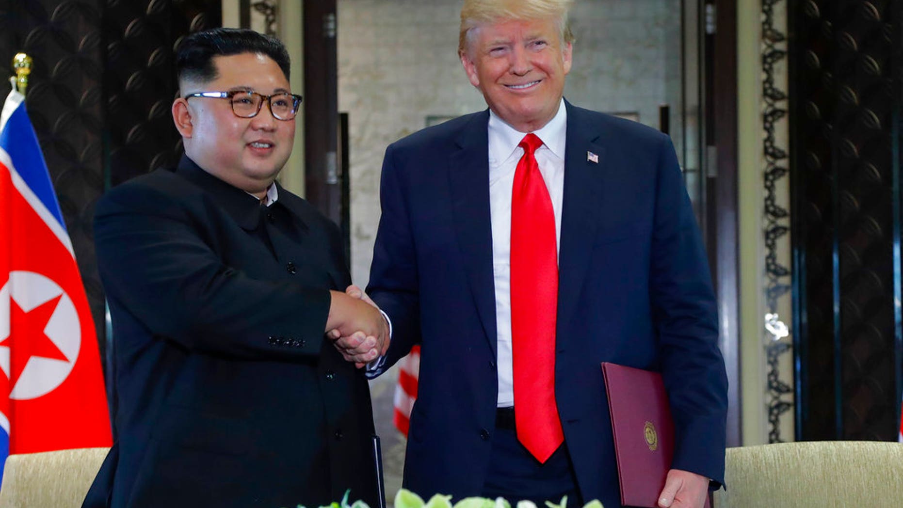 North Korea leader Kim Jong Un and U.S. President Donald Trump shake hands after a document signing at the Capella resort on Sentosa Island Tuesday, June 12, 2018 in Singapore. (AP Photo/Evan Vucci)