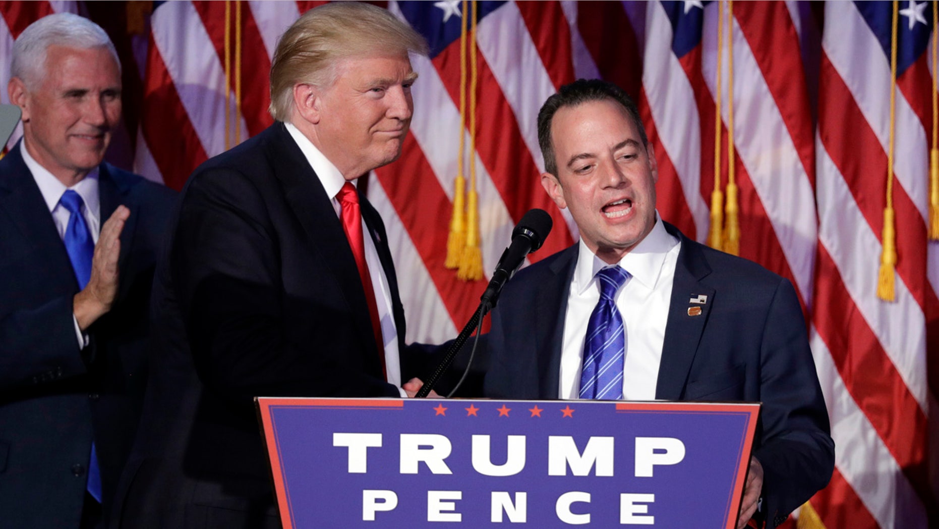 Nov. 9, 2016: Reince Priebus, Chair of the Republican National Committee, right, speaks as President-elect Donald Trump gives his acceptance speech during his election night rally in New York.