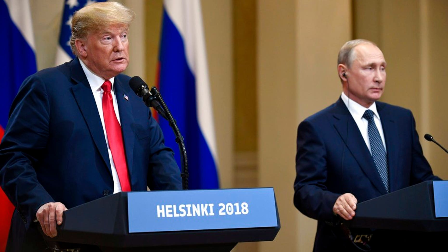 U.S. President Donald Trump speaks as Russian President Vladimir Putin listens during a join press conference at the Presidential Palace in Helsinki, Finland, Monday, July 16, 2018. (Antti Aimo-Koivisto/Lehtikuva via AP)