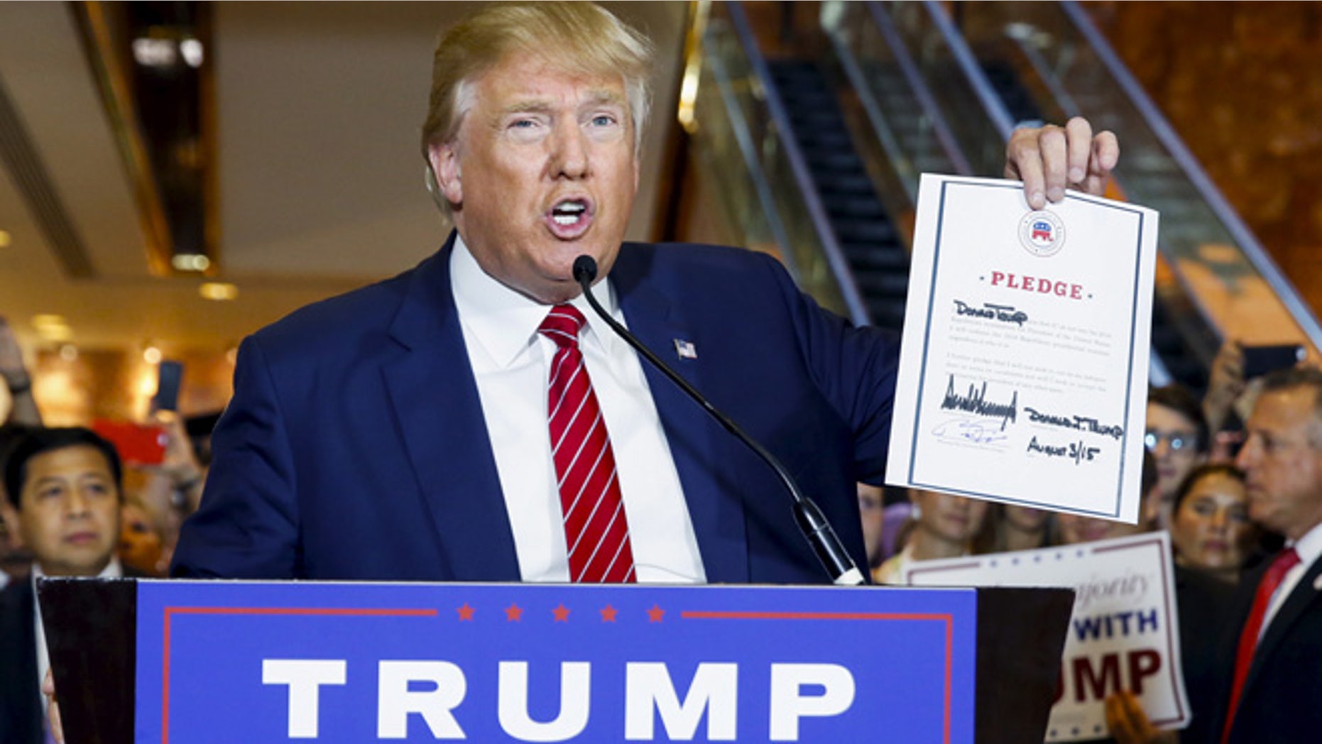 Sept. 3, 2015: U.S. presidential hopeful Donald Trump holds up a signed pledge during a press availability at Trump Tower in Manhattan, New York. (Reuters)