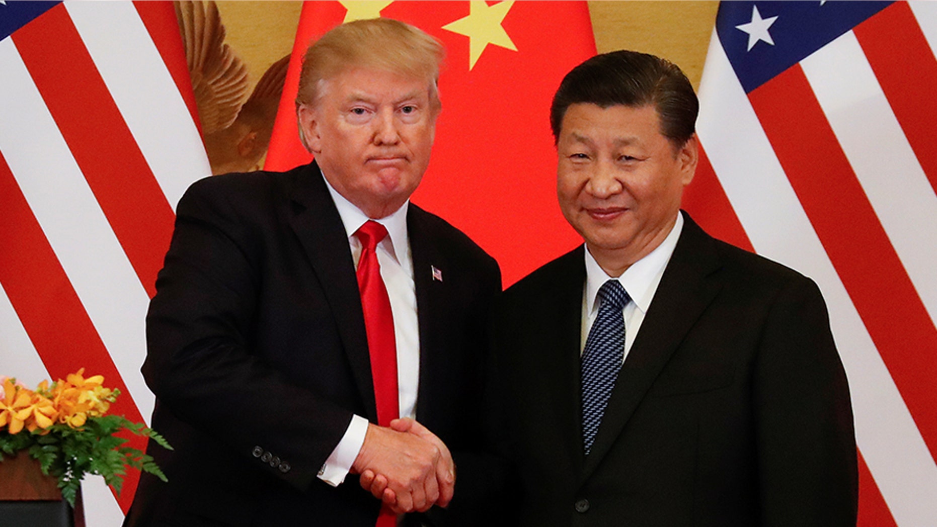 FILE -- President Donald Trump and China's President Xi Jinping make joint statements at the Great Hall of the People in Beijing, China, November 9, 2017.