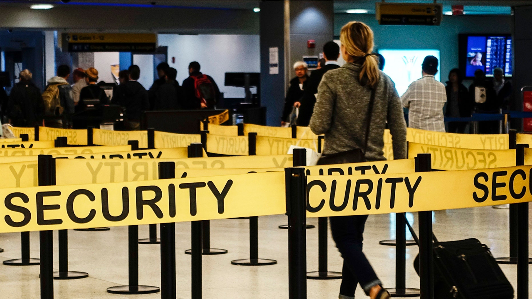 Passengers make their way in a security checkpoint at the International JFK airport in New York October 11, 2014.