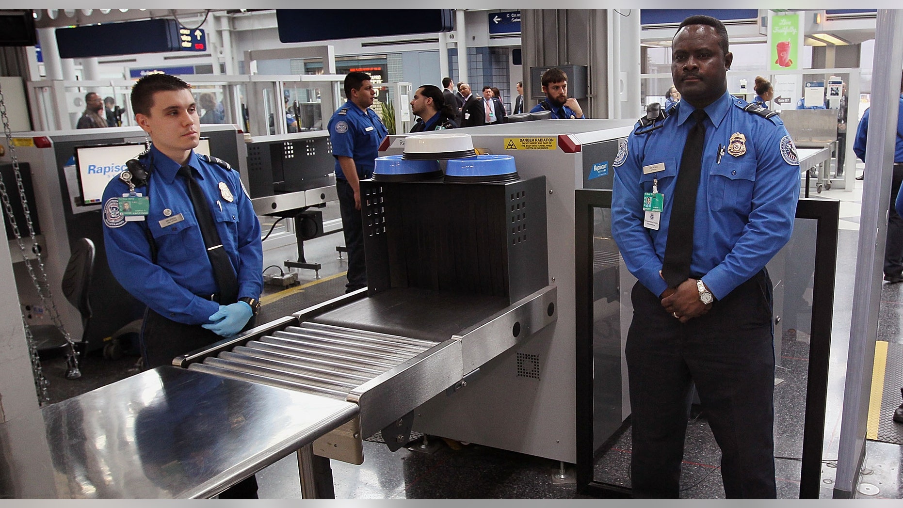 Transportation Security Administration (TSA) officers staff a checkpoint at O'Hare International Airport