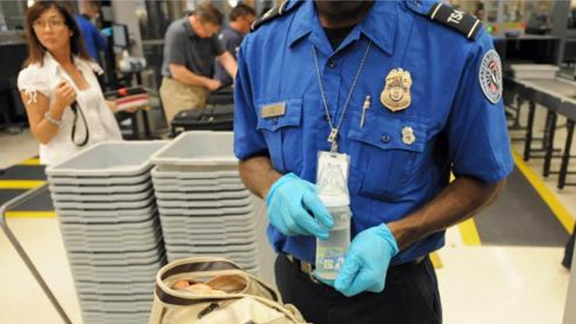 FILE: A Transportation Security Administration agent inspecting bags at Hartsfield–Jackson Atlanta International Airport.