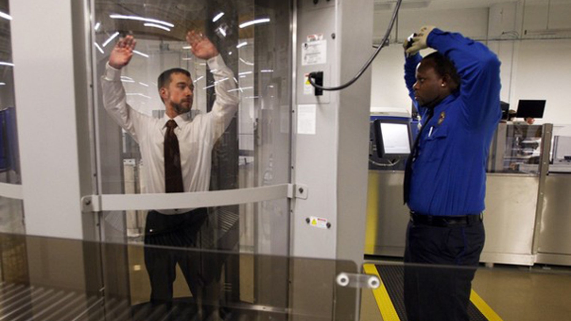 FILE: Undated: Transportation Security Administration staffers at the agency's Washington, D.C., training facility demonstrate a full-body scanning machine.