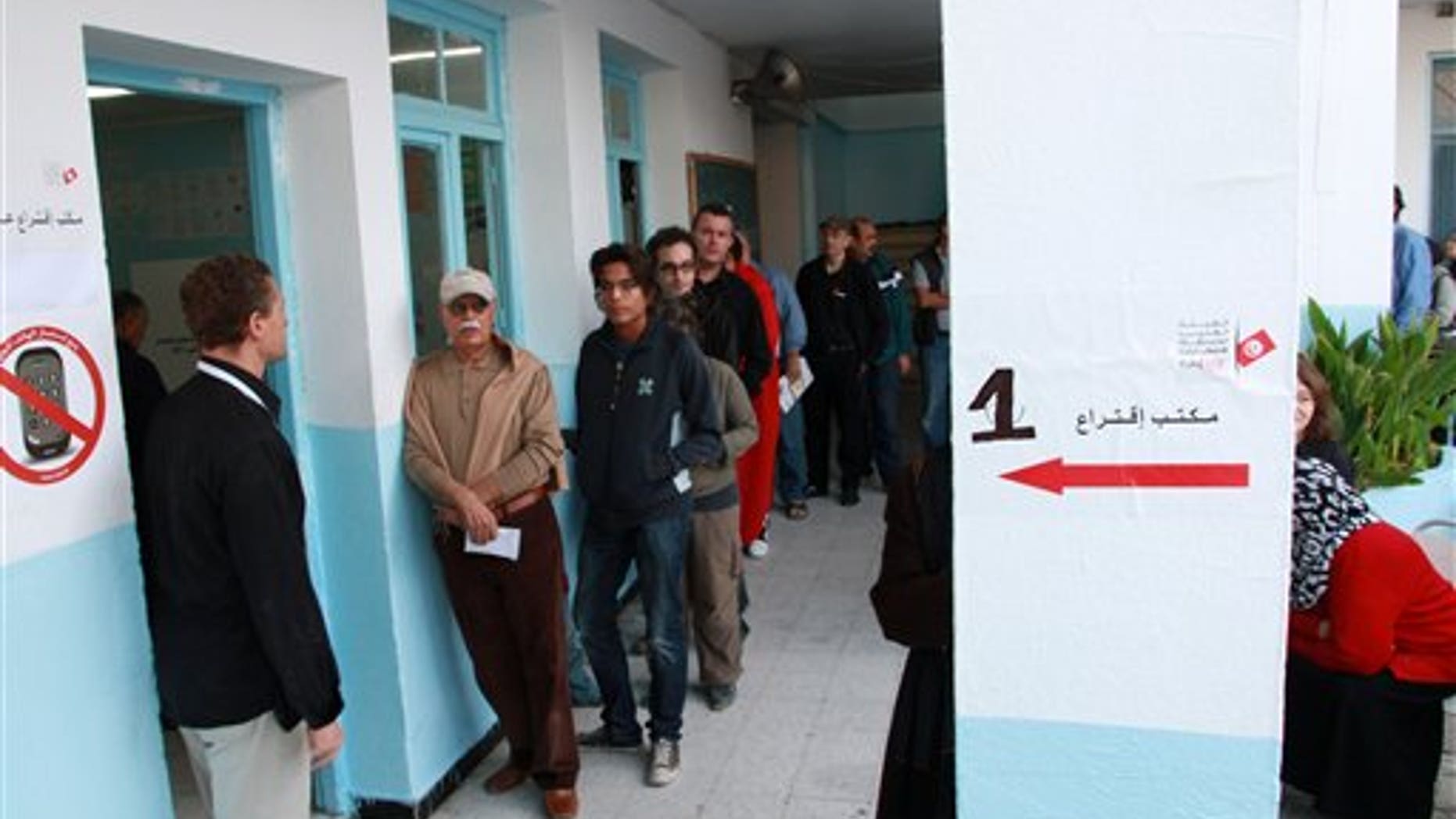 Oct. 21: Tunisians voters stand in a line outside the poling station in Menzeh near Tunis. Tunisians began voting Sunday in their first truly free elections, the culmination of a popular uprising that ended decades of authoritarian rule and set off similar rebellions across the Middle East.