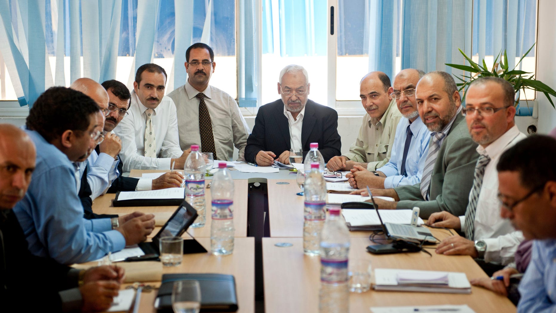 Oct. 27, 2011: Tunisian leader and founder of the moderate islamist party Ennahda, Rached Ghannouchi, center right, chairs an executive board at the party's headquarters in Tunis.