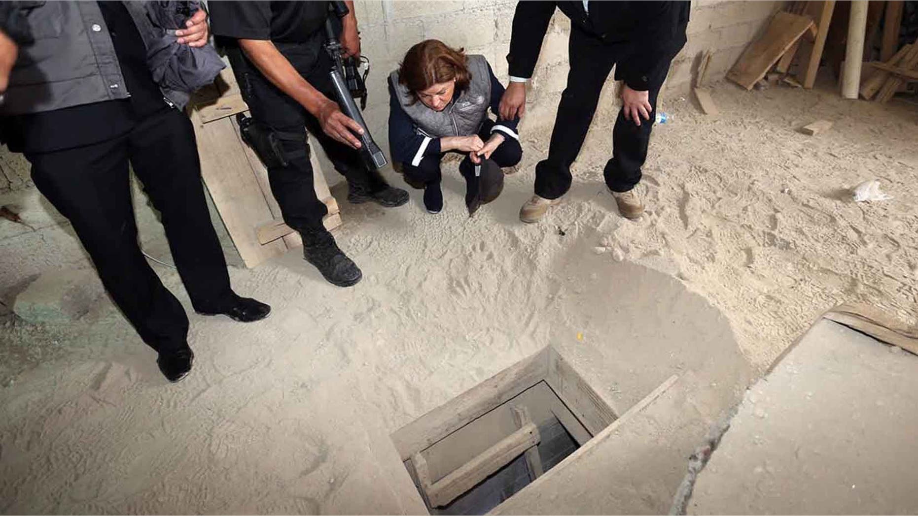 Authorities inspect the exit of the tunnel used by Joaquin "El Chapo" Guzman on Sunday, July 12, 2015.