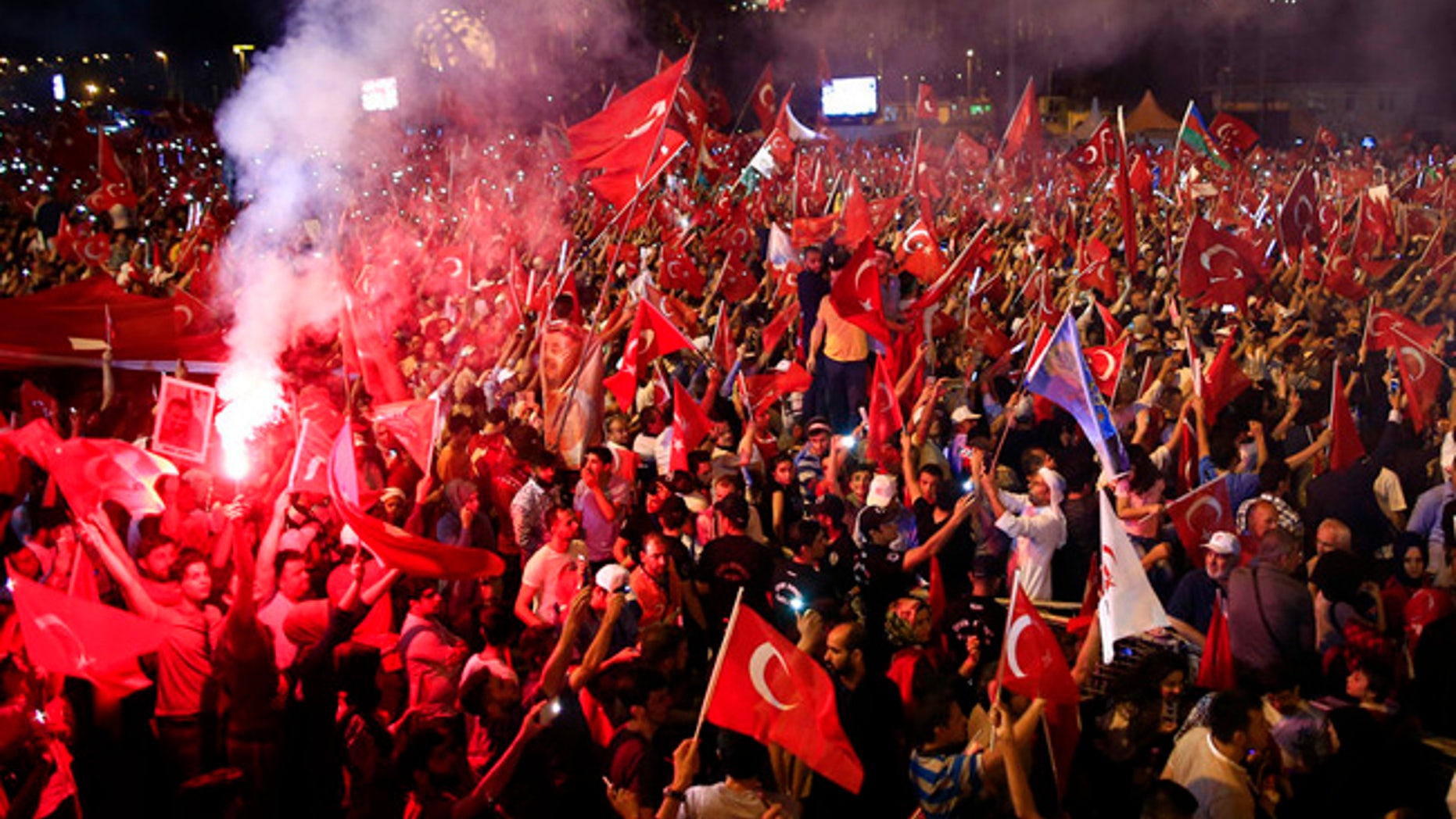 Crowd cheer as Turkey's President Recep Tayyip Erdogan speaks at the July 15 Martyr's bridge on a "National Unity March" to commemorate the one year anniversary of the July 15, 2016 botched coup attempt, in Istanbul, Saturday, July 15, 2017. Turkey commemorates the first anniversary of the July 15 failed military attempt to overthrow president Erdogan, with a series of events honoring some 250 people, who were killed across Turkey while trying to oppose coup-plotters. (AP Photo/Lefteris Pitarakis)