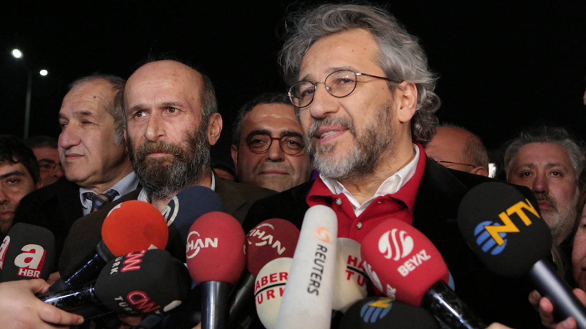 Feb. 26, 2016: Can Dundar, the editor-in-chief of opposition newspaper Cumhuriyet, right, and Erdem Gul, the paper's Ankara representative, front-left, speak to the media outside Silivri prison near Istanbul.