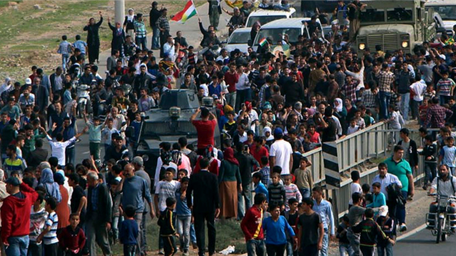 Oct. 29, 2014: Cheering local people surround a group of Iraqi Kurdish Peshmerga troops arrived in Nusaybin, Mardin in southeastern Turkey. The Peshmergas are on their way to Syria to help Syrian Kurds fighting Islamic State extremists in the embattled border town of Kobani.