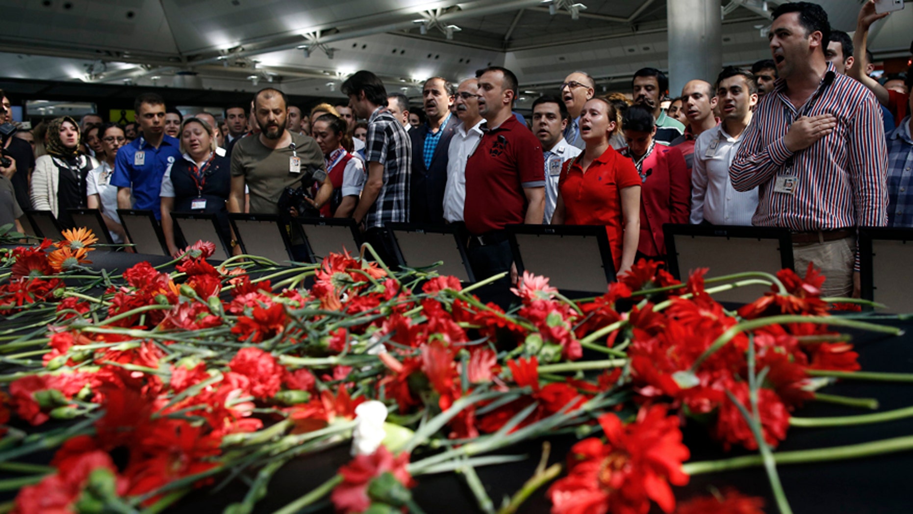 June 30, 2016: Family members, colleagues and friends of the victims of Tuesday blasts gather for a memorial ceremony at the Ataturk Airport in Istanbul.