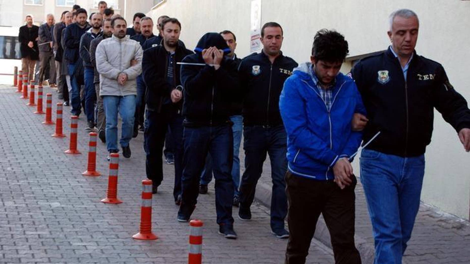 Suspected supporters of the U.S.-based cleric Fethullah Gulen escorted by plainclothes police officers at police headquarters in Kayseri, Turkey, on Tuesday.