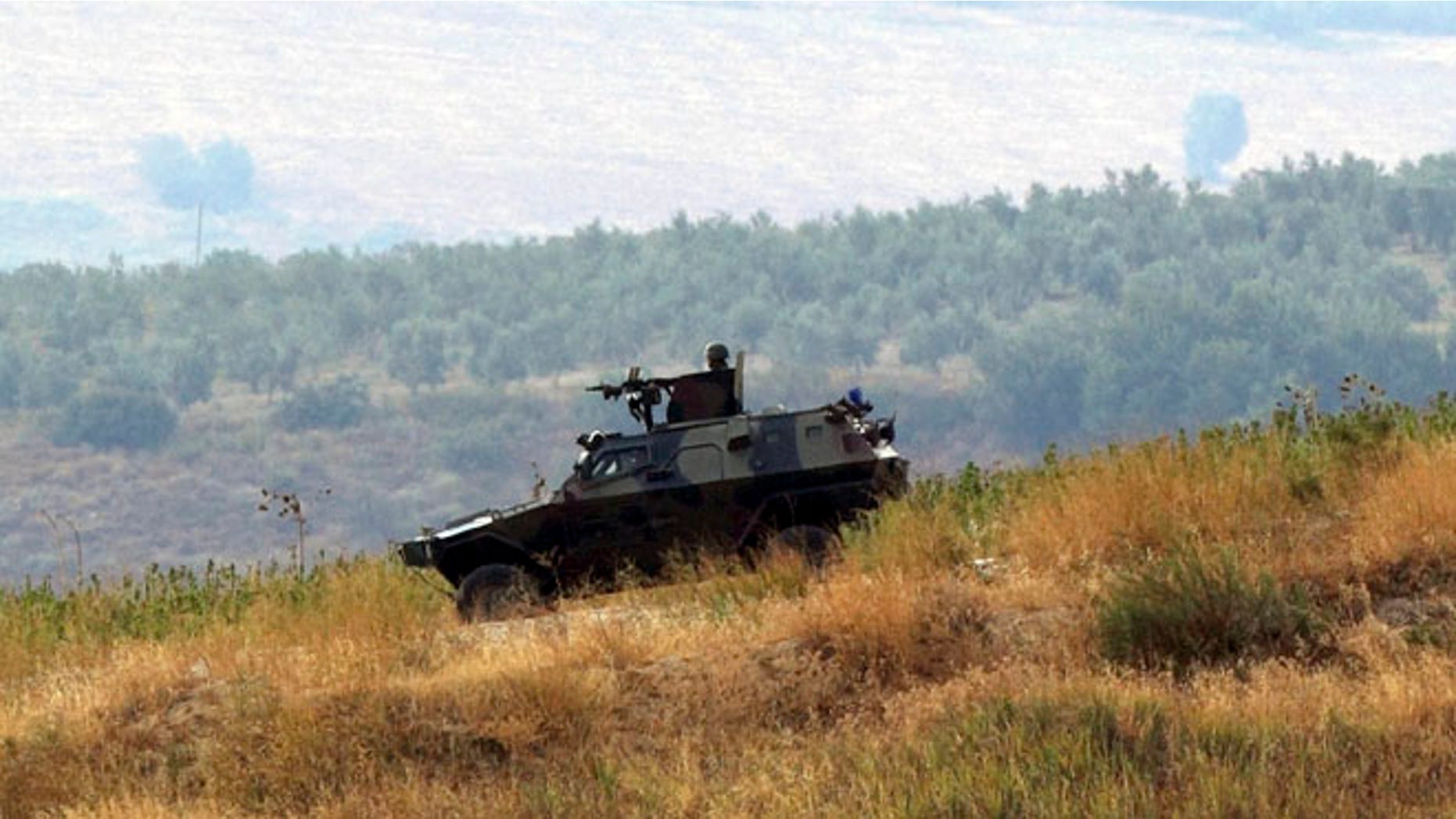 Oct. 9, 2012: Turkish soldiers in a military vehicle patrol on the Turkish-Syrian border near the village of Hacipasa in Hatay province, southern Turkey.