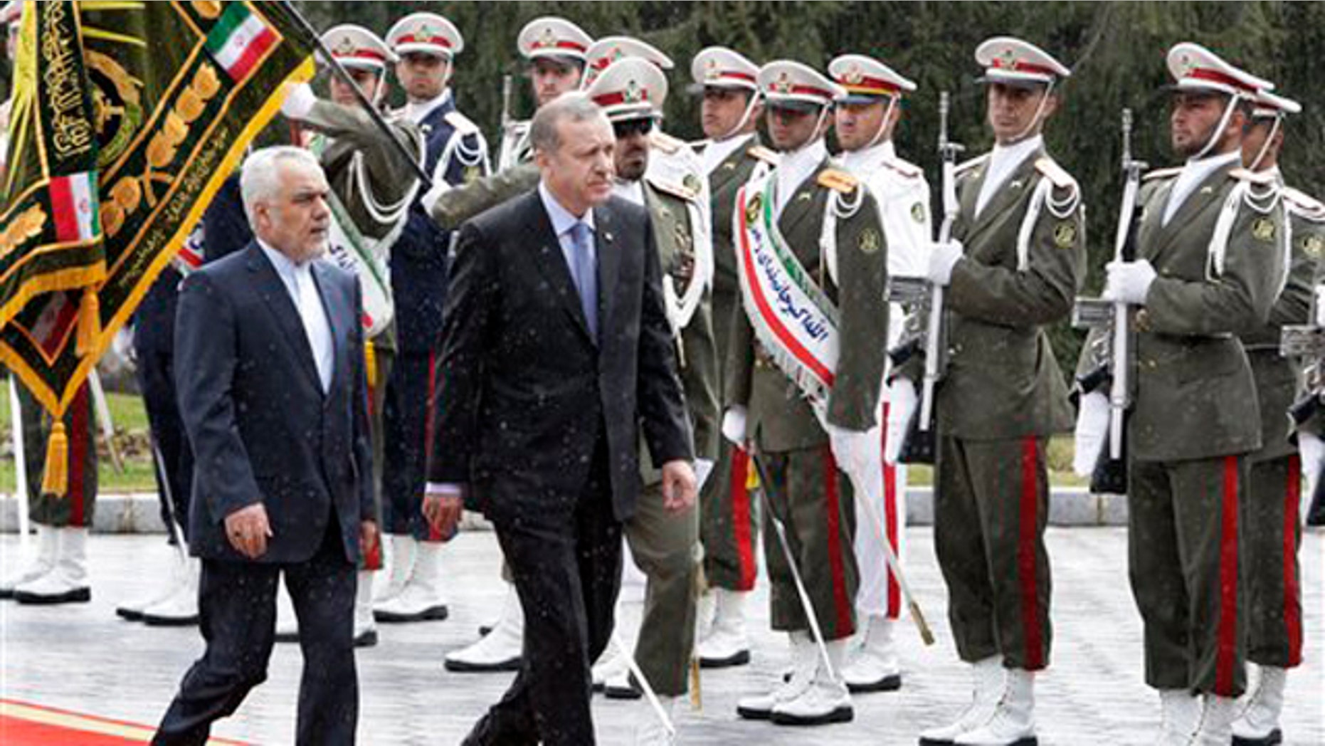 March 28, 2012: Turkish Prime Minister, Recep Tayyip Erdogan, right, is accompanied by Iranian Vice-President Mohammad Reza Rahimi, left, during an official welcoming ceremony in Tehran, Iran.