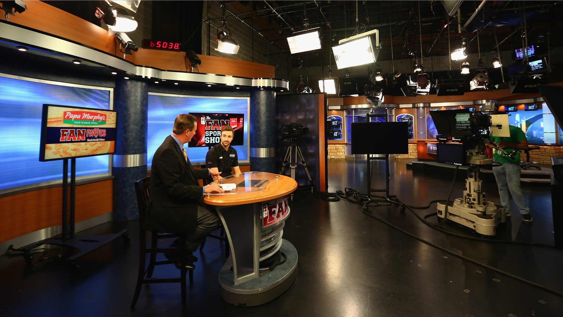 FORT WORTH, TX - JUNE 06: IndyCar Series driver James Hinchcliffe co-hosts The Fan Sports Show with anchor Bill Jones at the TXA television studio on June 6, 2013 in Fort Worth, Texas. (Photo by Tom Pennington/Getty Images)