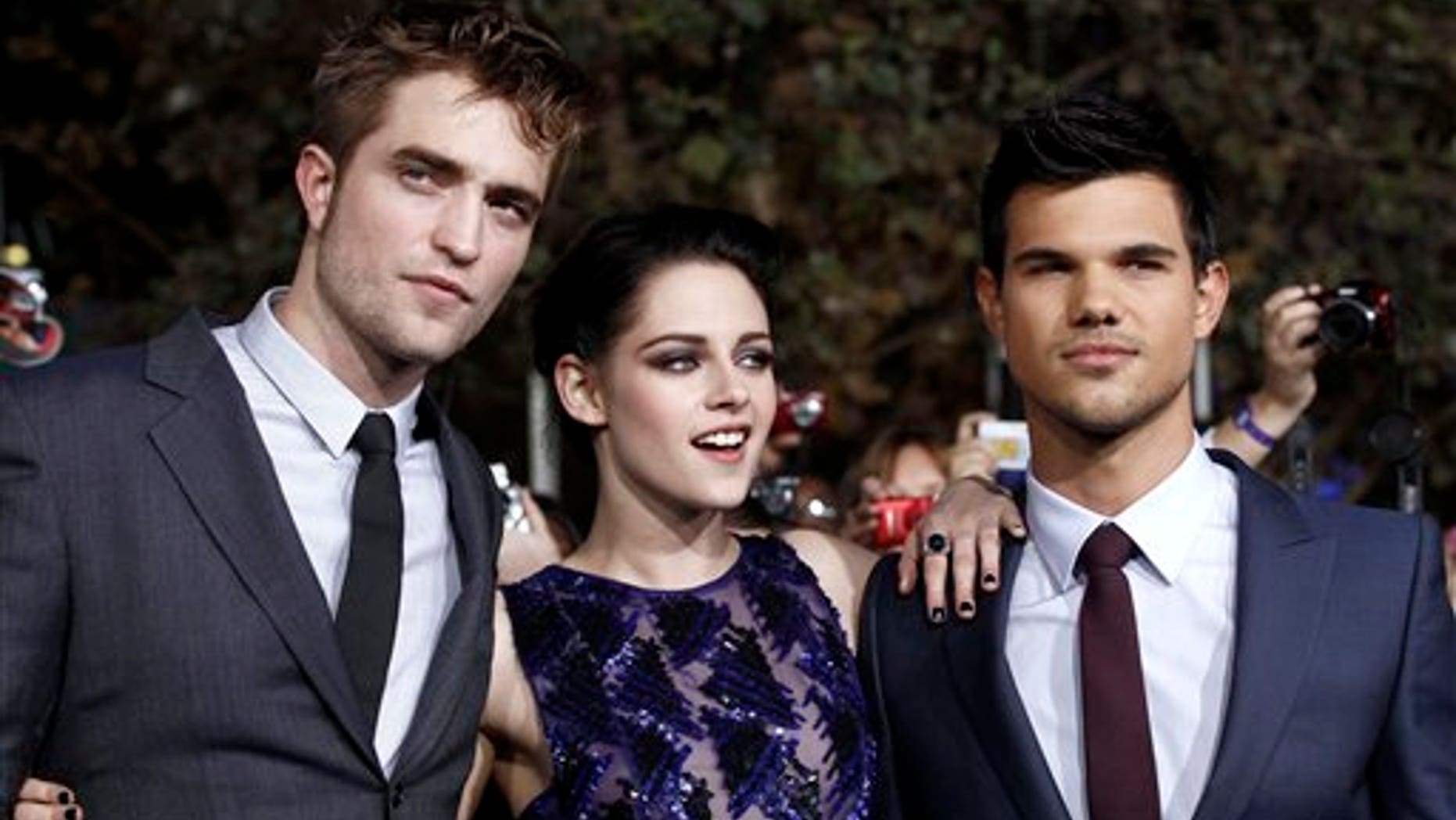 Nov. 14. 2011: Robert Pattinson, left, Kristen Stewart, center, and Taylor Lautner arrive at the world premiere of "The Twilight Saga: Breaking Dawn - Part 1," in Los Angeles.