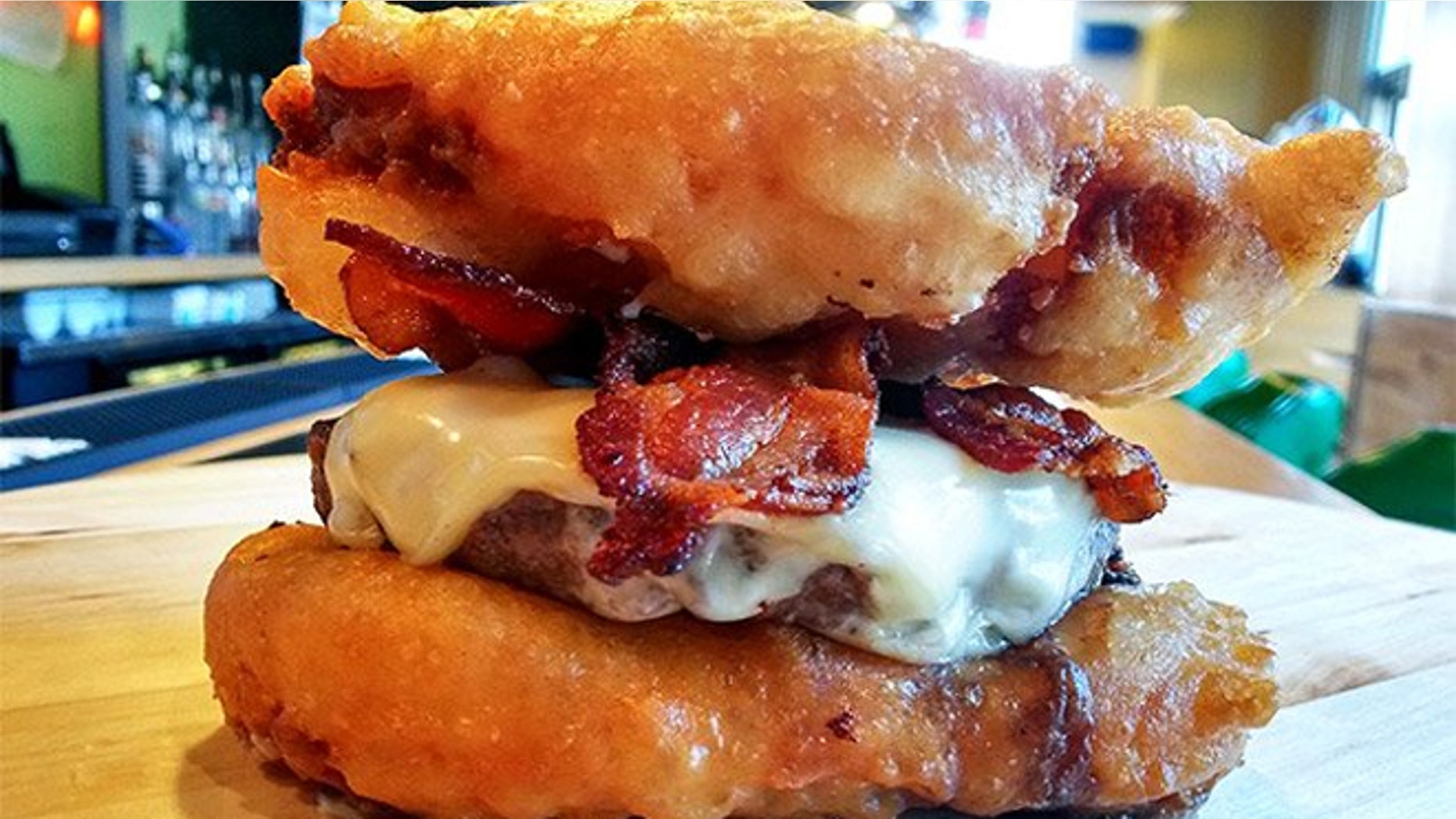 Deep-fried Twinkie Burger is made with two deep-fried Twinkies, a pork belly patty, American cheese and extra bacon.