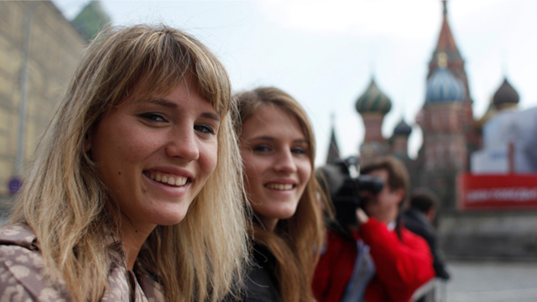May 3: Twin sisters Jennifer, left, and Jessica, pose for a photo in front of St. Basil's Cathedral in the Red Square in Moscow, Russia. More than 16 years after their American adoptive parents traveled to Russia to collect two malnourished 2-year-old girls named Galina and Svetlana, the twins, now Jessica and Jennifer Allen, have made their first trip back to Children's Home No. 13, reclaiming their Russian heritage, discovering to their delight they feel at home in Russia, too. (AP)