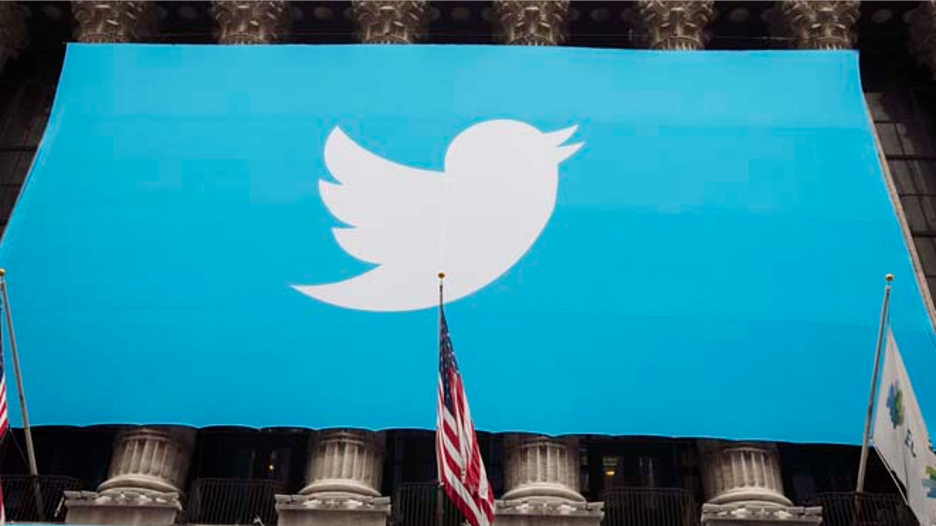 A sign displays the Twitter logo on the front of the New York Stock Exchange in New York, Nov. 7, 2013.