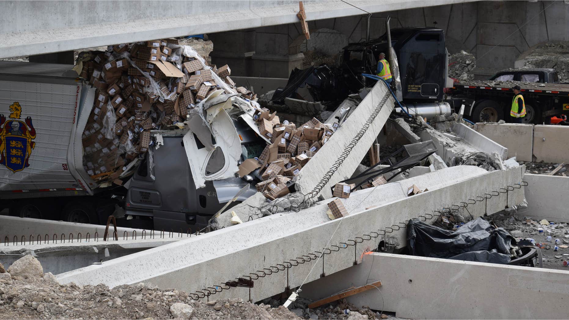 March 26, 2015: Authorities investigate a tractor-trailer that crashed into an overpass under construction.