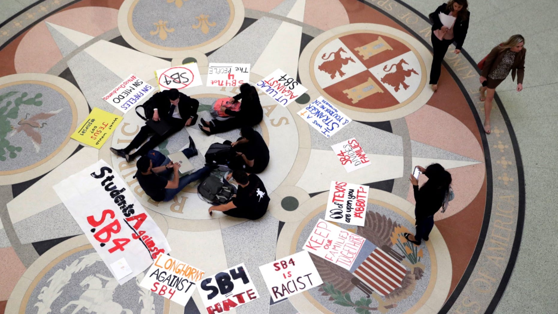 In this April 26, 2017, file photo, students gather in the Rotunda at the Texas Capitol to oppose SB4, an anti-"sanctuary cities" bill that seeks to jail sheriffs and other officials who refuse to help enforce federal immigration law.