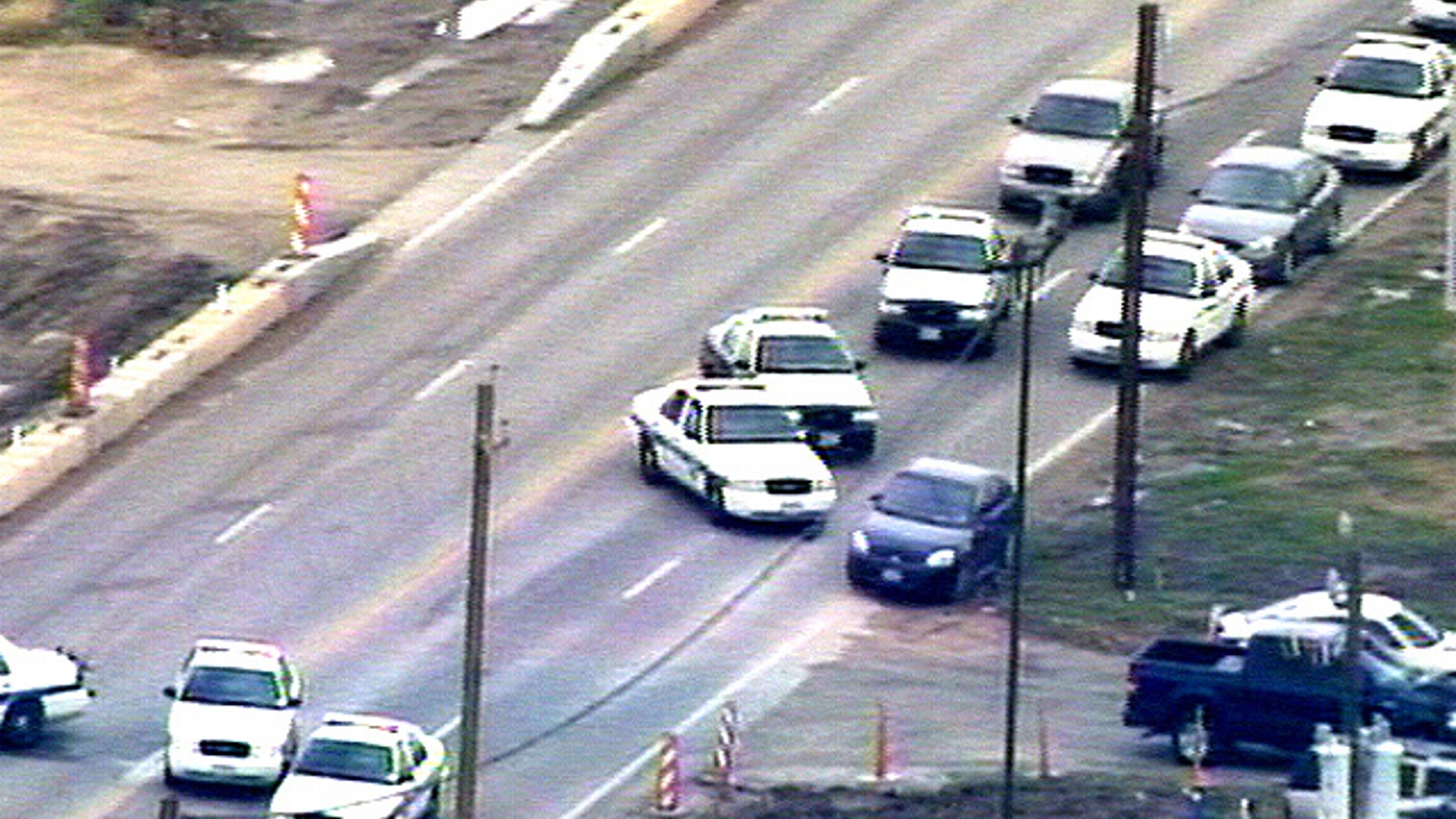 Police block road during Pearland, TX bank robbery.