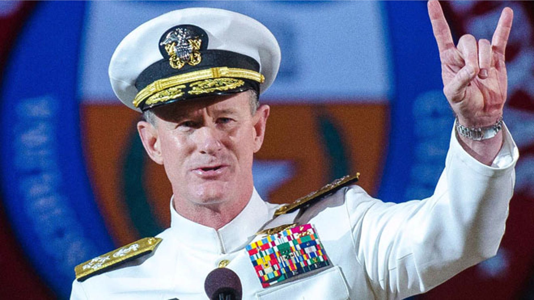 May 17, 2014: Naval Adm. William H. McRaven, an alumnus, does the Longhorns' Hook 'em Horns hand signal during his commencement keynote address at the University of Texas in Austin.